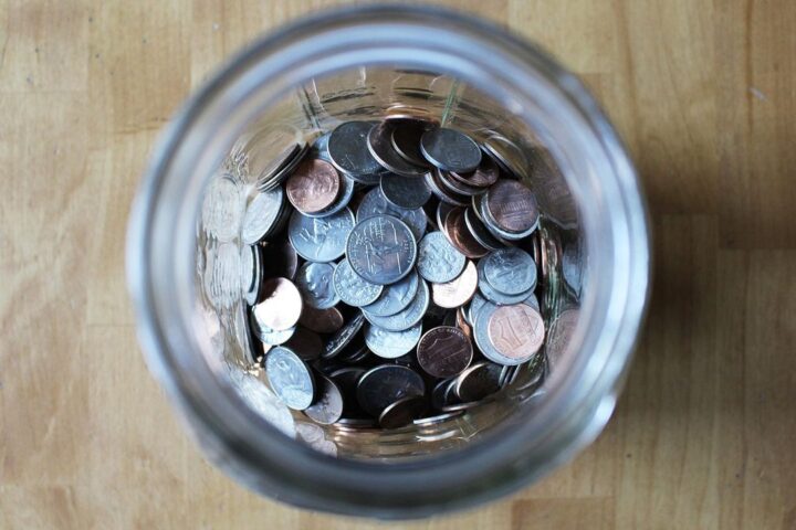 Jar full of saved coins seen from above