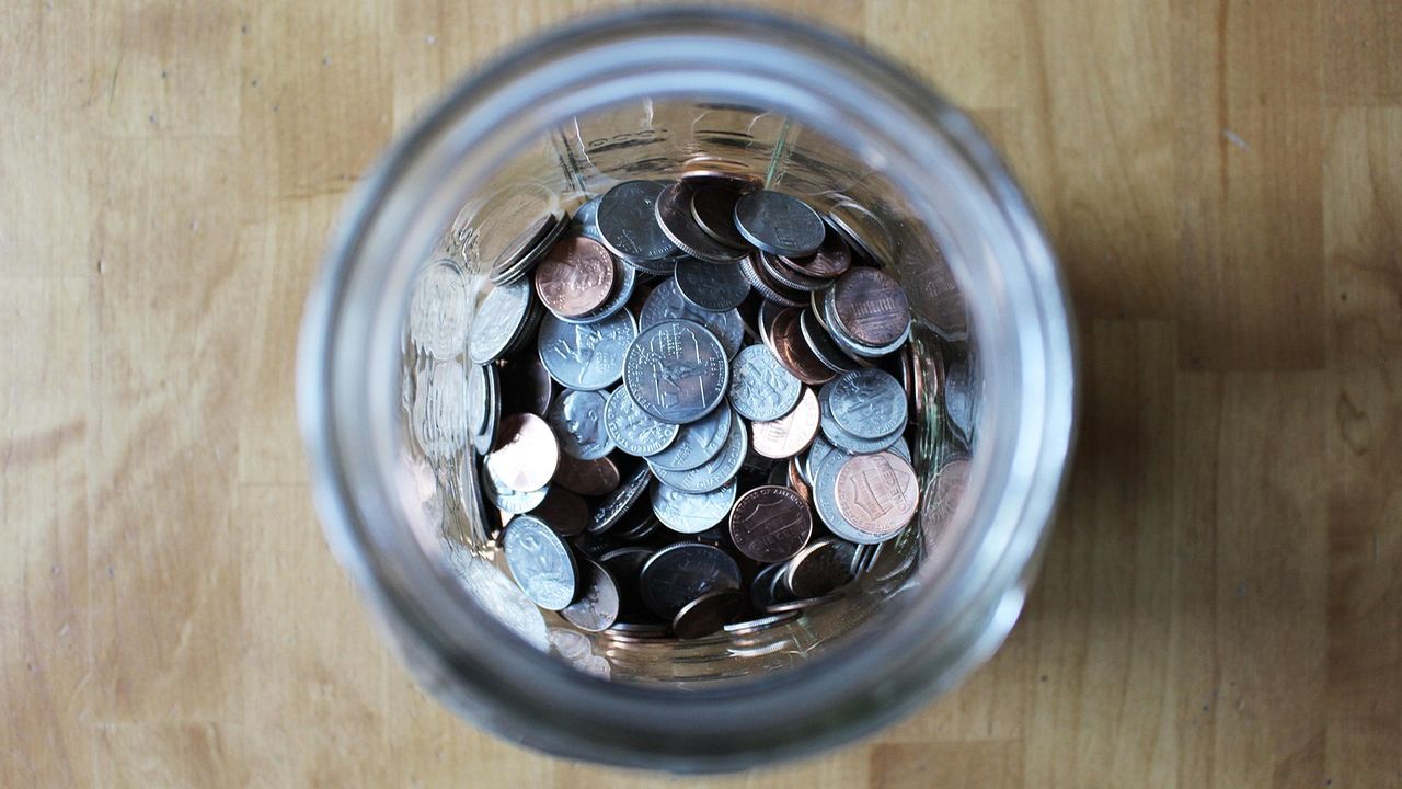 Jar full of saved coins seen from above