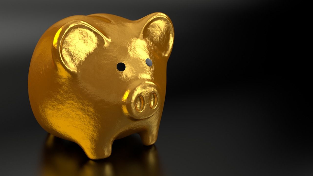 Gold piggy bank on a dark background