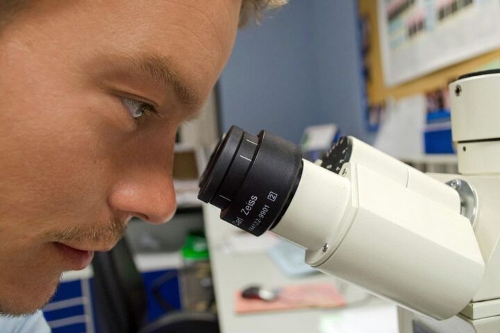 Scientist looking into a microscope