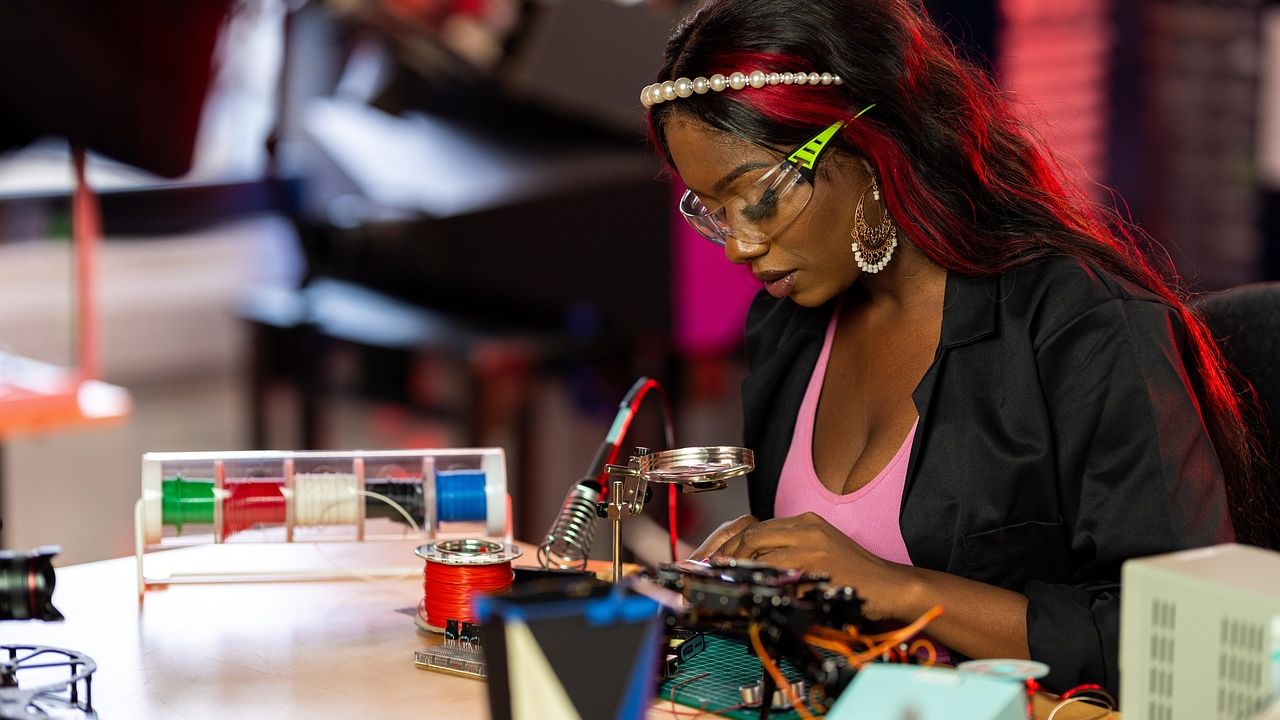 Young woman soldering electronics at a workbench