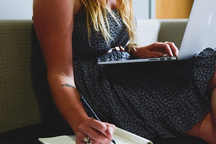 Woman working on a laptop on the sofa