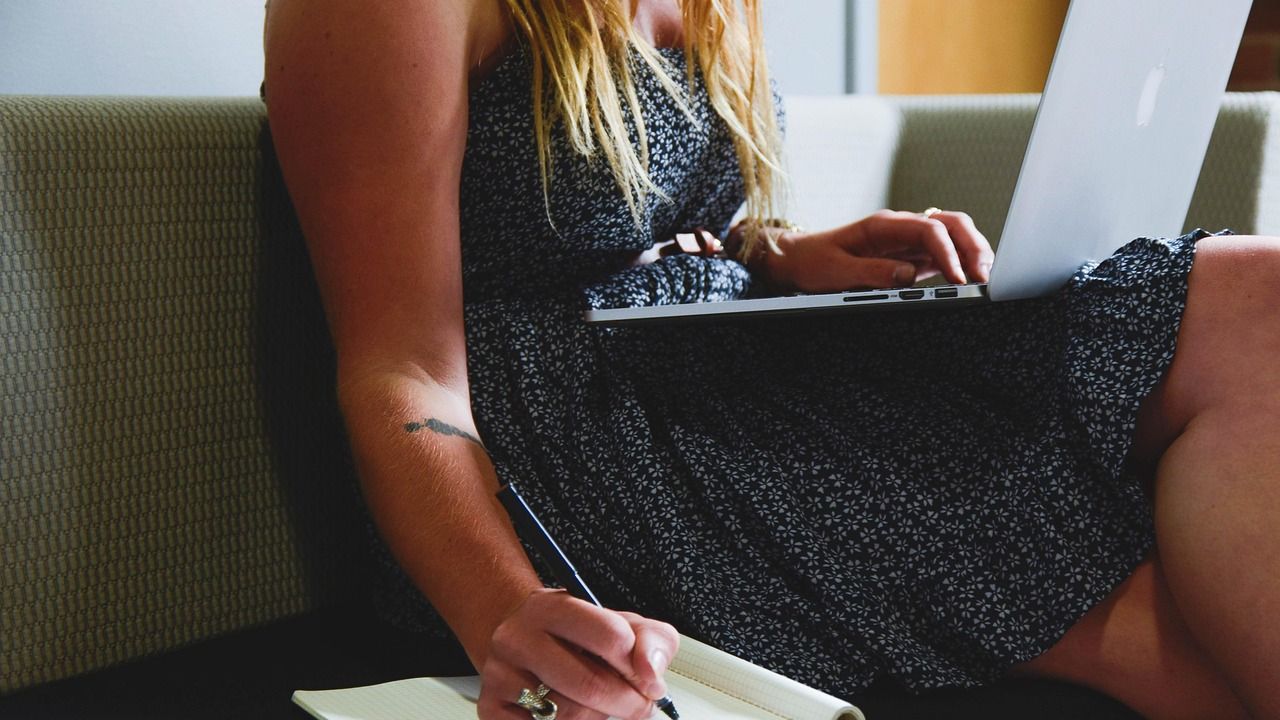Woman working on a laptop on the sofa