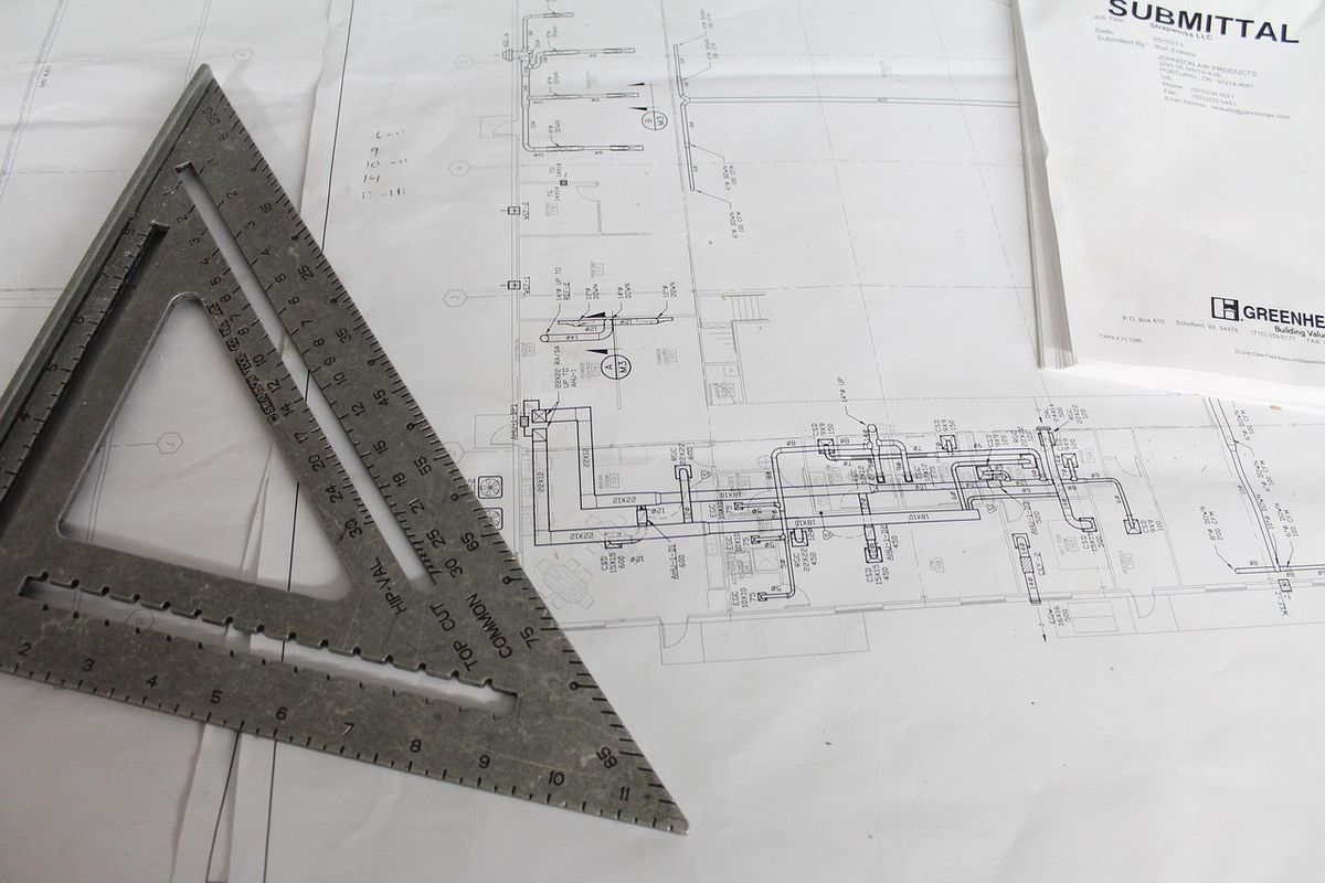 Set square resting on building plans