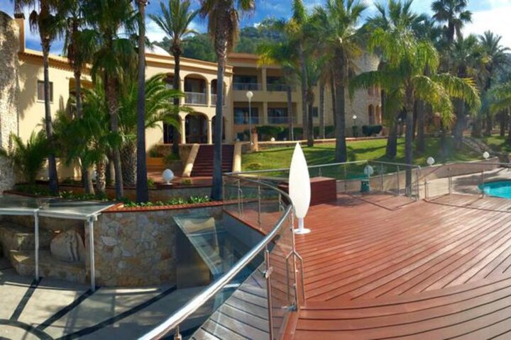 Mansion terrace and pool among palm trees in Ibiza