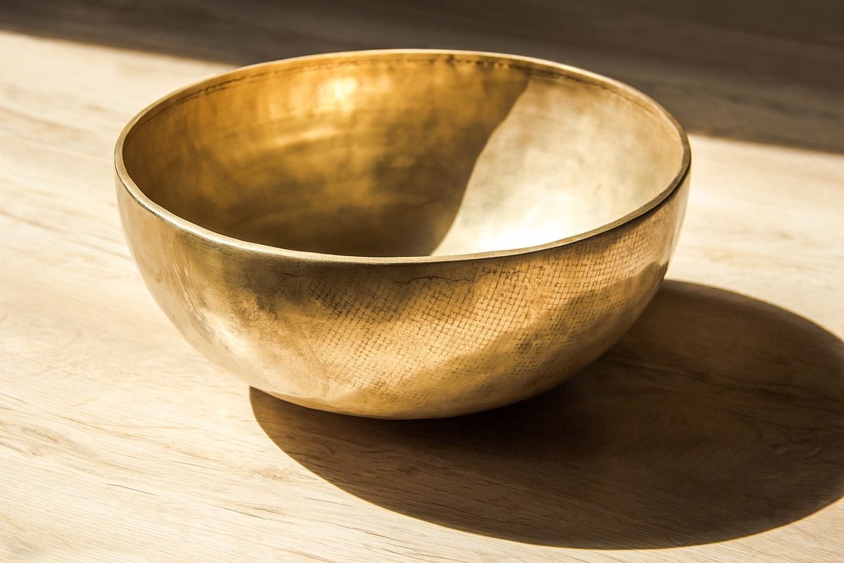 Brass singing bowl in warm sunlight