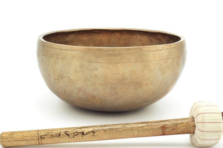 Brass singing bowl with a wooden mallet