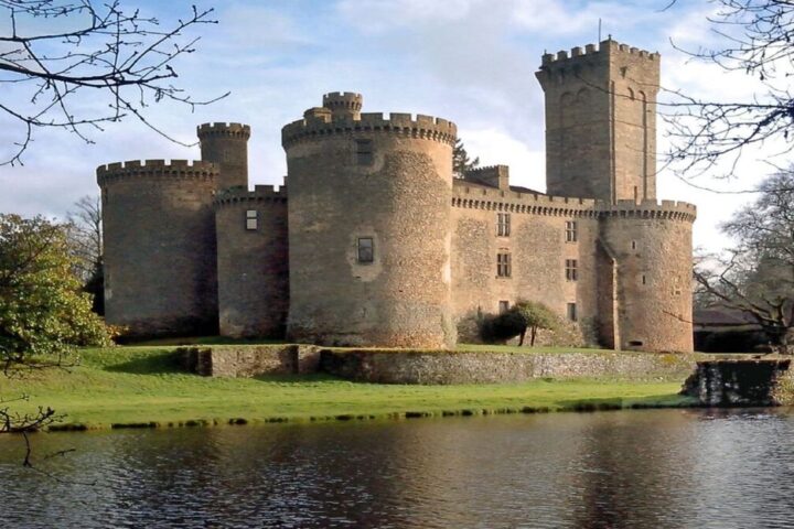 Medieval French château with round towers beside a moat