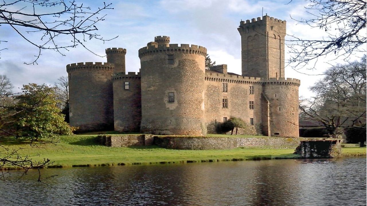 Medieval French château with round towers beside a moat