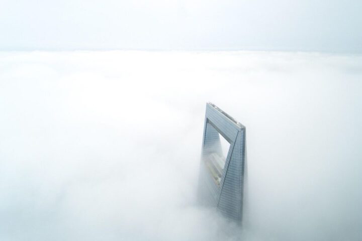 Skyscraper rising above a sea of fog