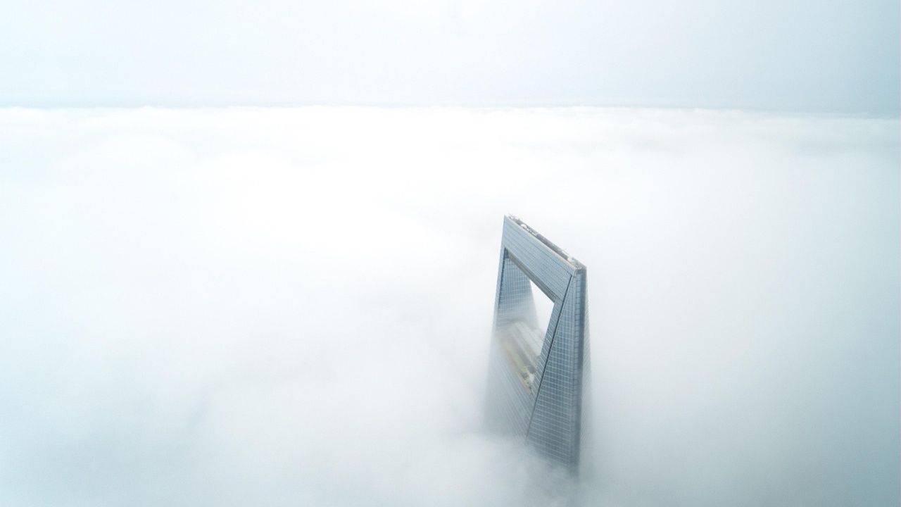 Skyscraper rising above a sea of fog