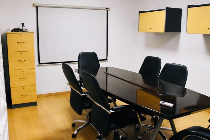Modern meeting room with a black table and chairs