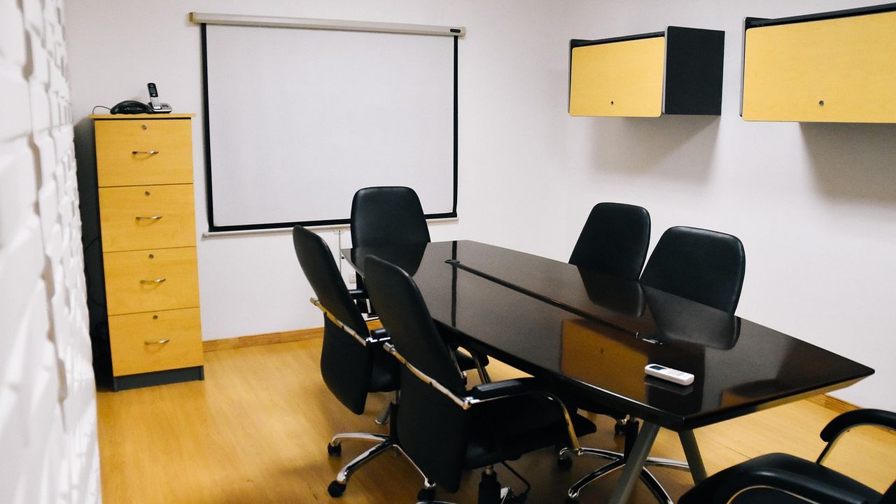 Modern meeting room with a black table and chairs