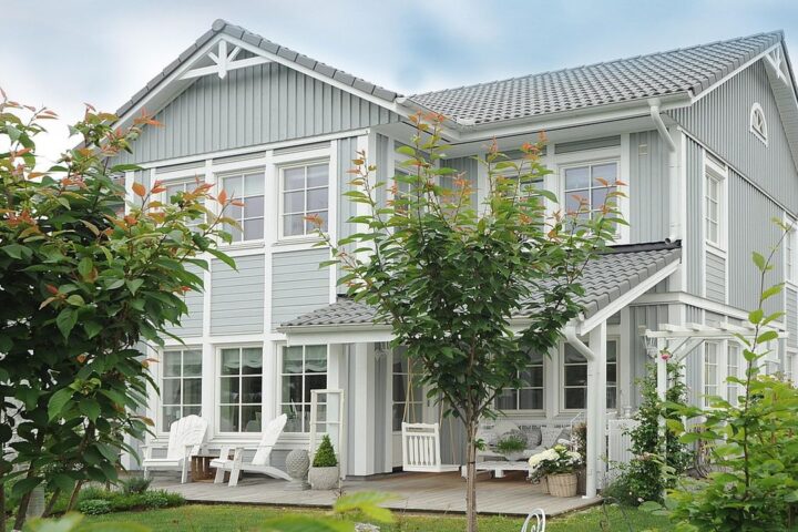 Grey weatherboard family house with a front garden