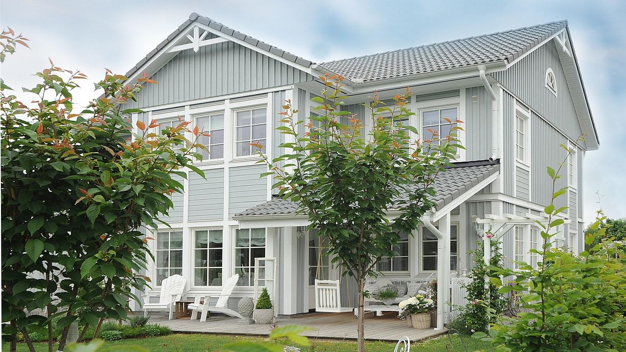 Grey weatherboard family house with a front garden