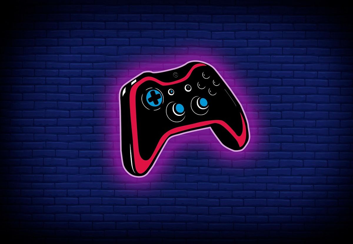Neon game controller sign on a brick wall