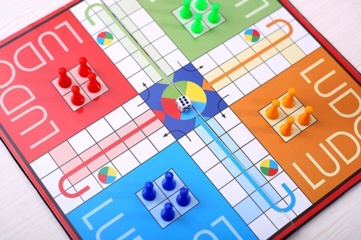 Ludo board game with coloured counters and a die