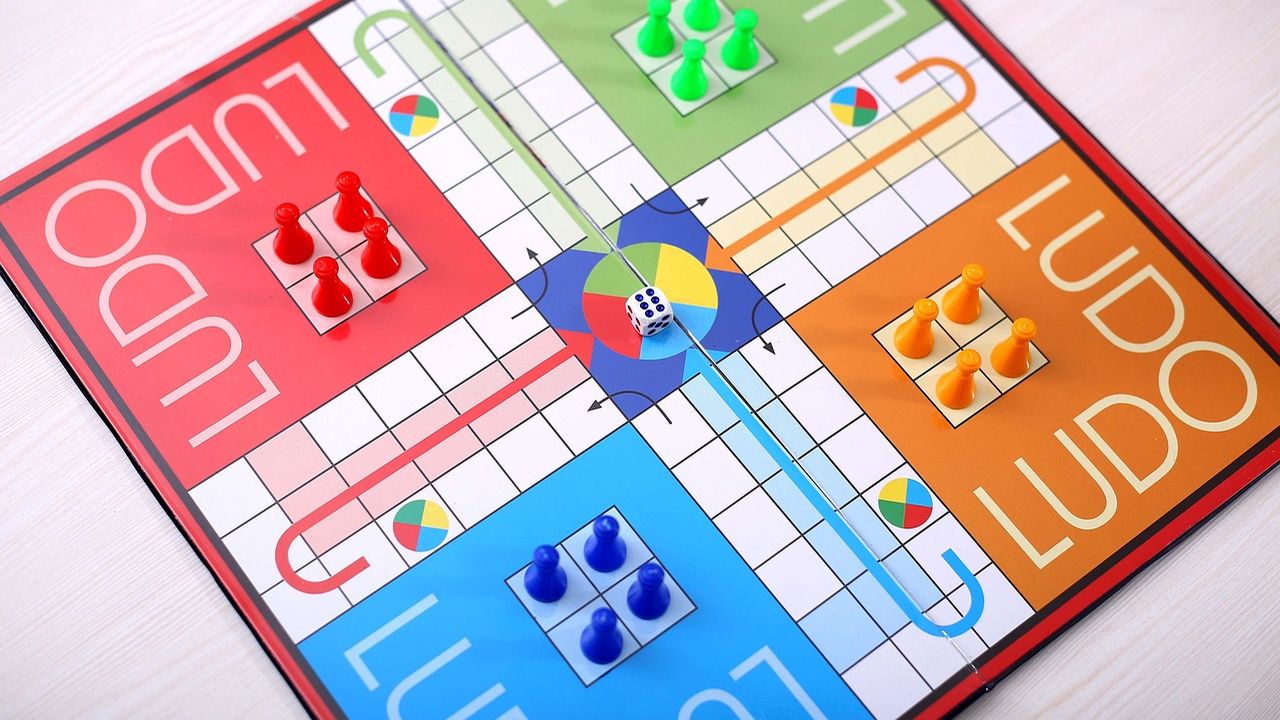 Ludo board game with coloured counters and a die