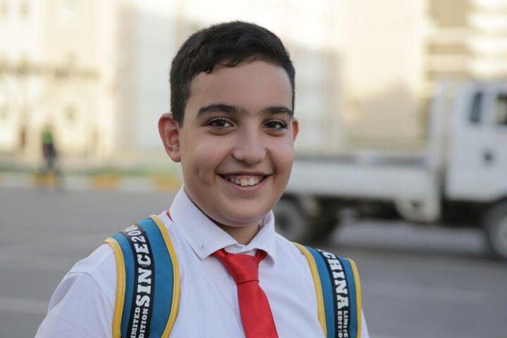 Smiling schoolboy with a backpack