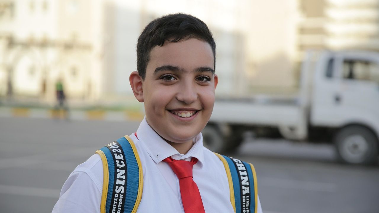 Smiling schoolboy with a backpack
