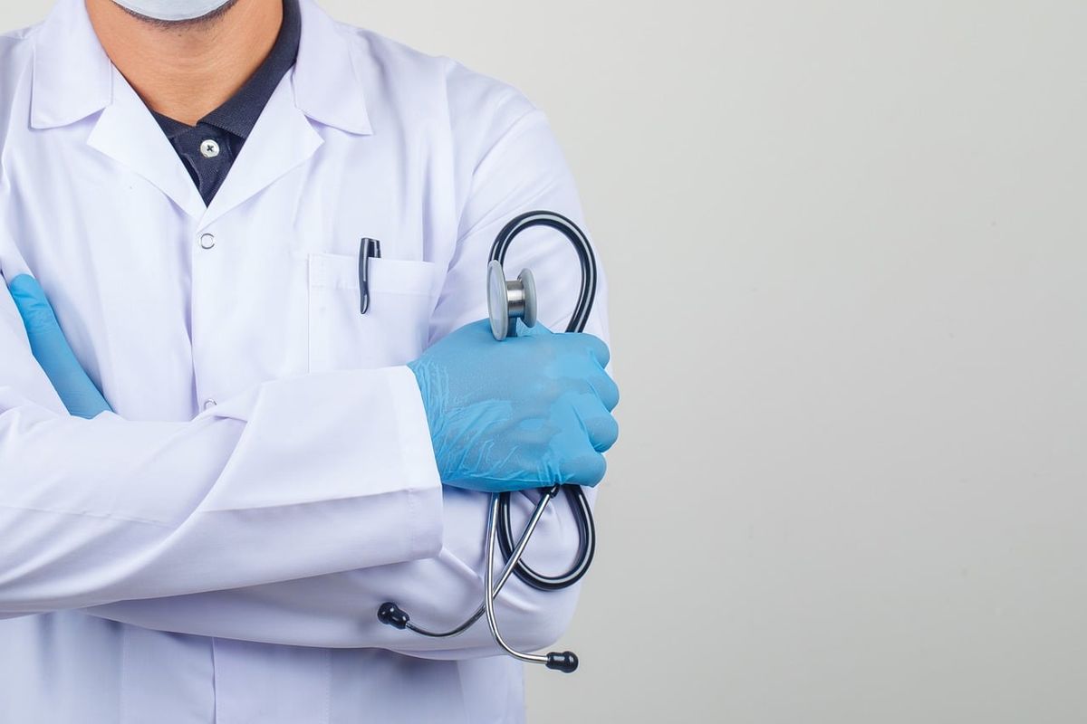 Doctor in a white coat holding a stethoscope