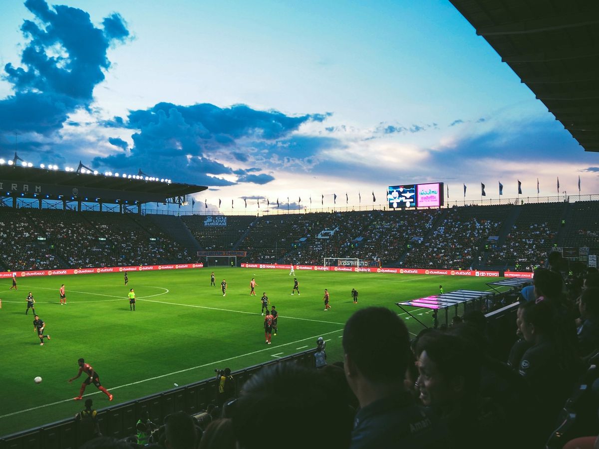 Football match in a stadium at sunset