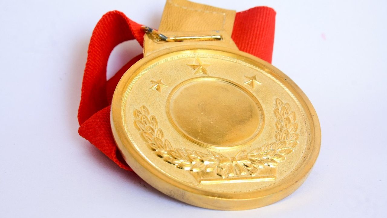 Gold medal with a red ribbon
