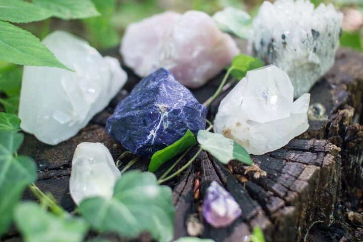 Rose quartz, amethyst and clear crystals among leaves