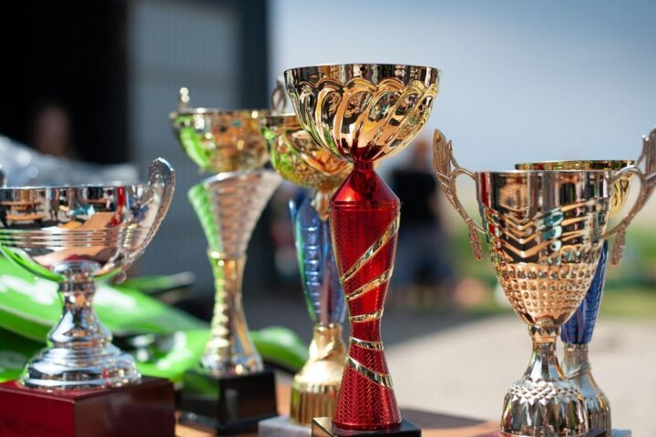 Row of gold and silver trophy cups on a table