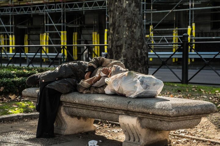 Person sleeping rough on a park bench