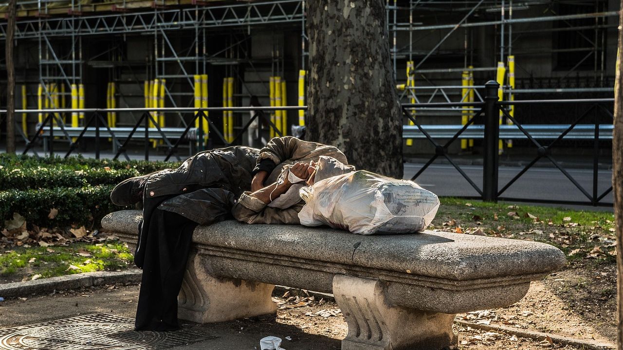 Person sleeping rough on a park bench