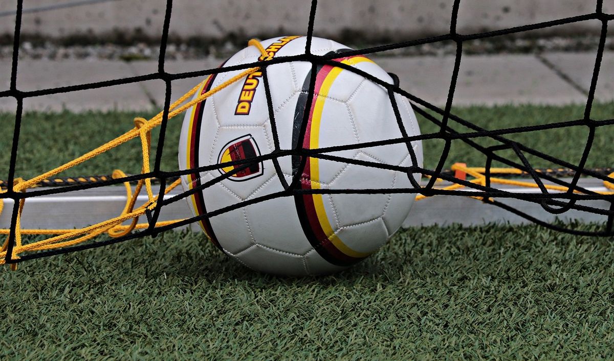 Football caught in the back of a goal net