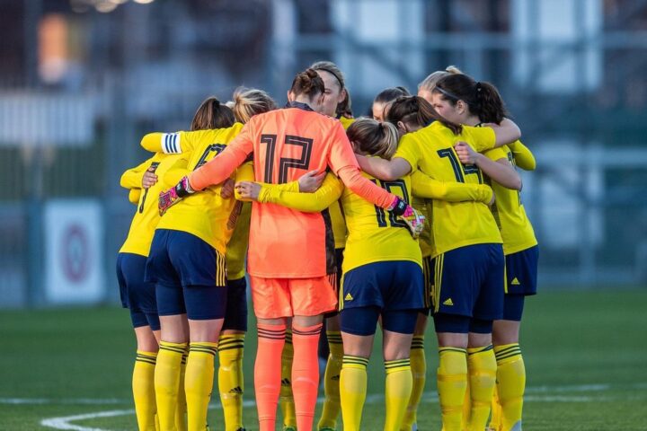 Women's football team in a huddle before a match