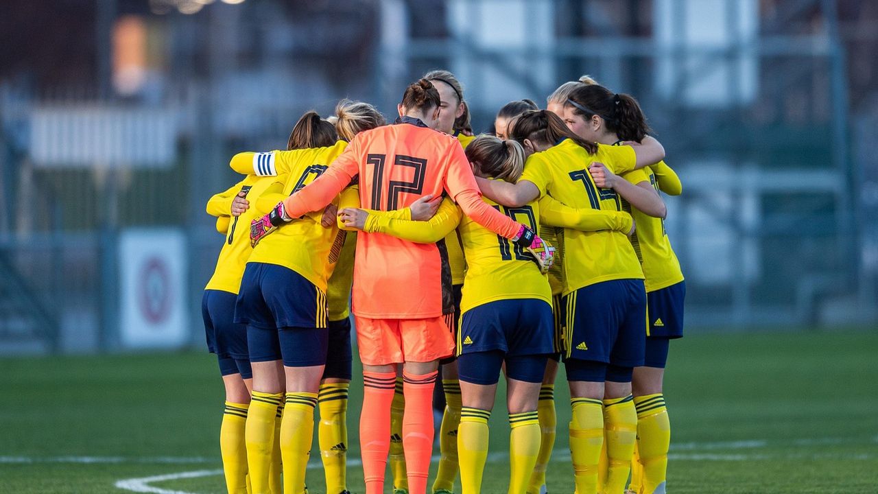 Women's football team in a huddle before a match