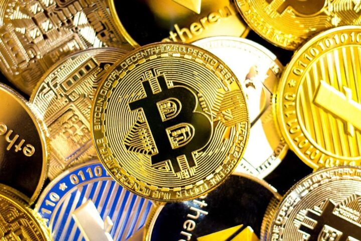 Pile of gold cryptocurrency coins including bitcoin and ethereum