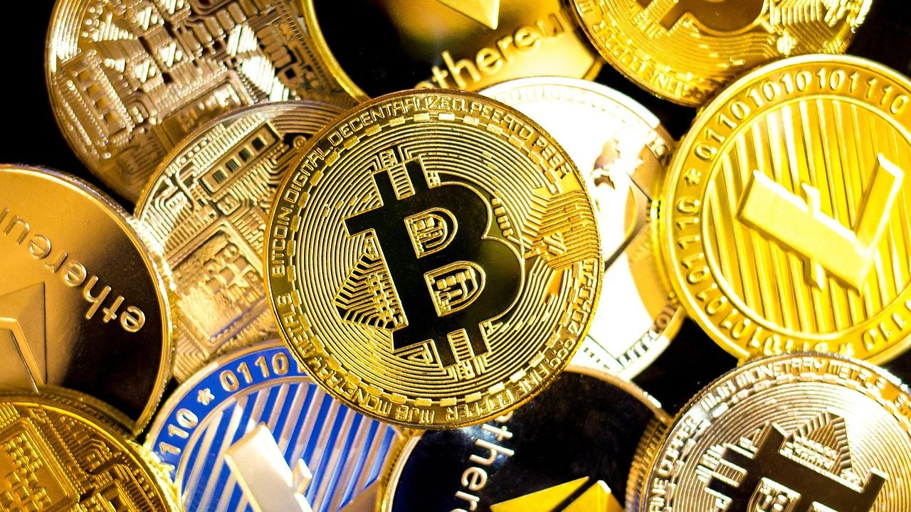 Pile of gold cryptocurrency coins including bitcoin and ethereum