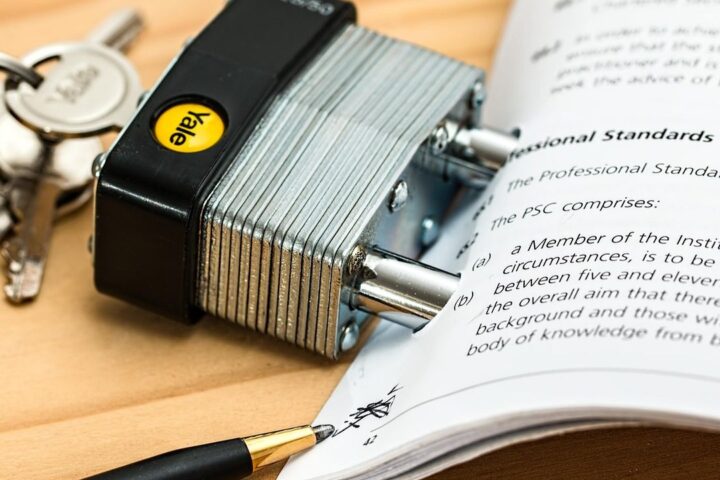 Padlock and keys resting on an open law book