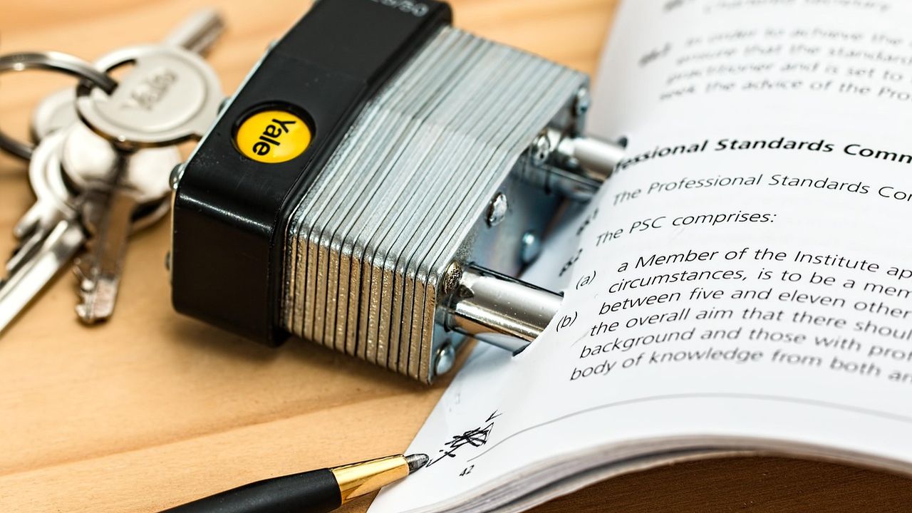 Padlock and keys resting on an open law book