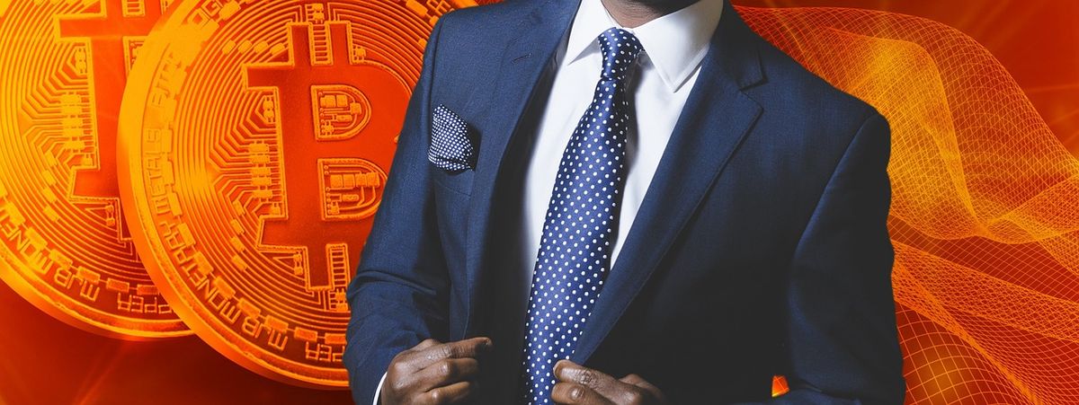 Businessman in a suit beside glowing bitcoin graphics