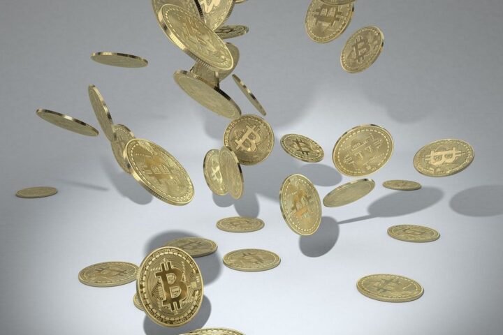 Gold bitcoin coins falling through the air