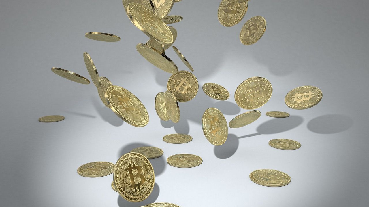 Gold bitcoin coins falling through the air