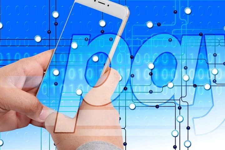 Hand holding a phone in front of a digital payment graphic