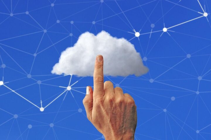 Finger touching a cloud linked to a digital network