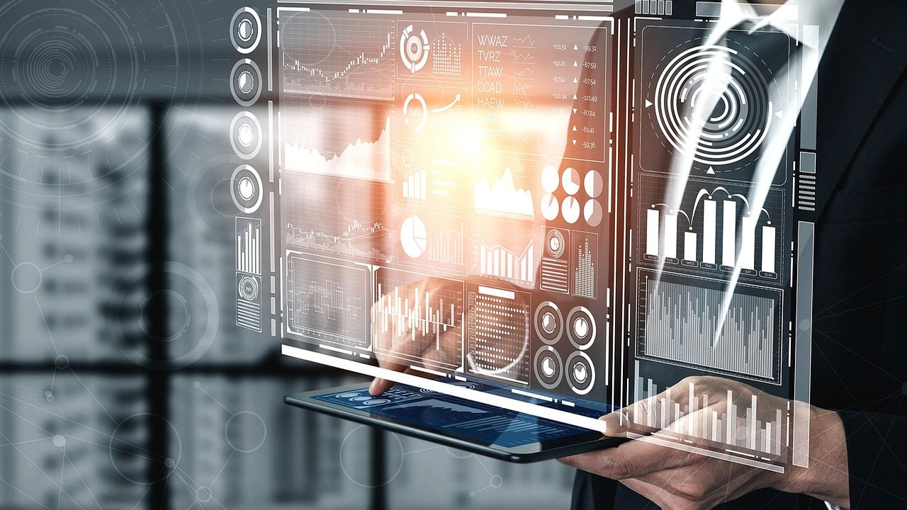 Businessman using a holographic data dashboard