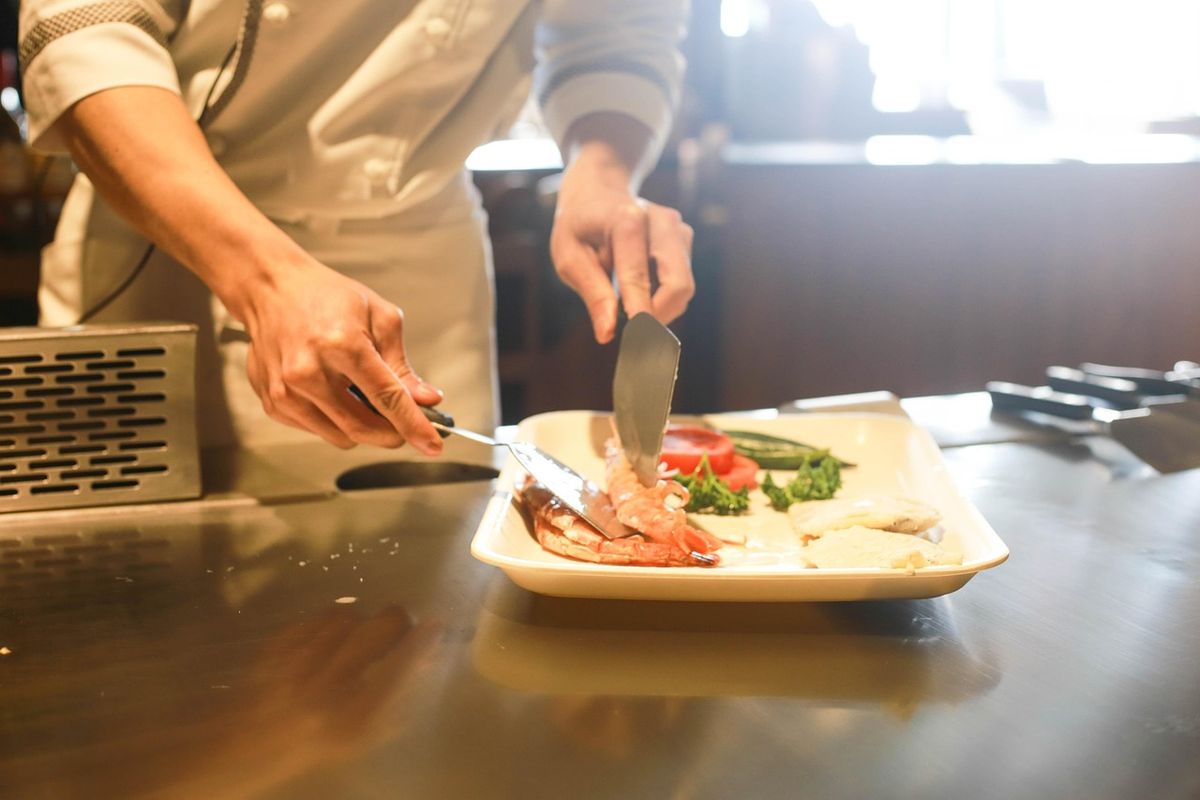 Chef plating a dish in a restaurant kitchen