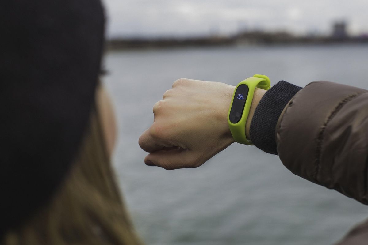 Fitness tracker band on a wrist by the water