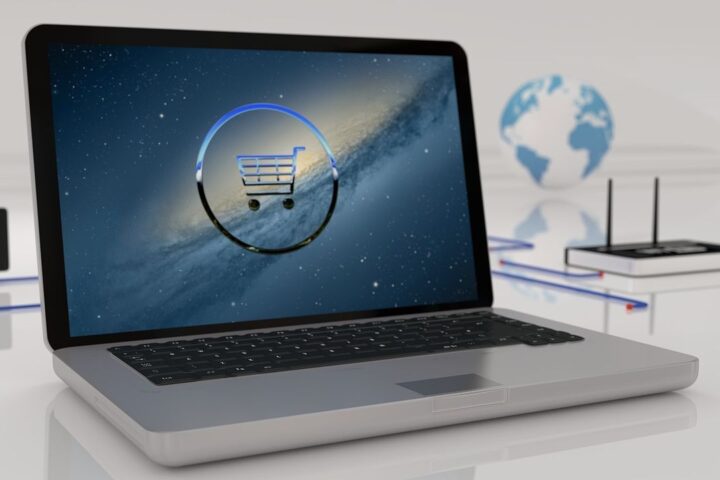 Laptop with a shopping cart icon and a globe