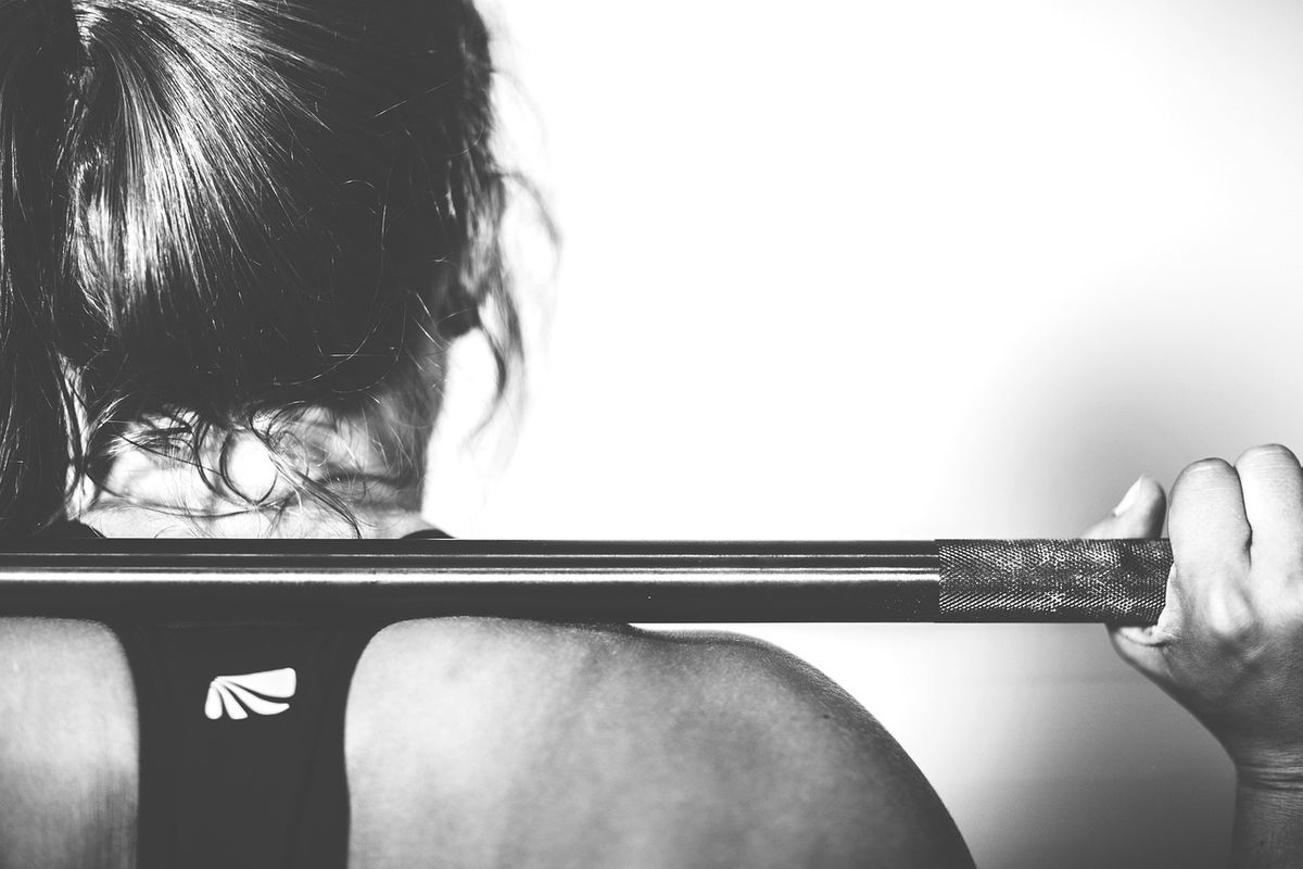 Woman gripping a barbell in the gym