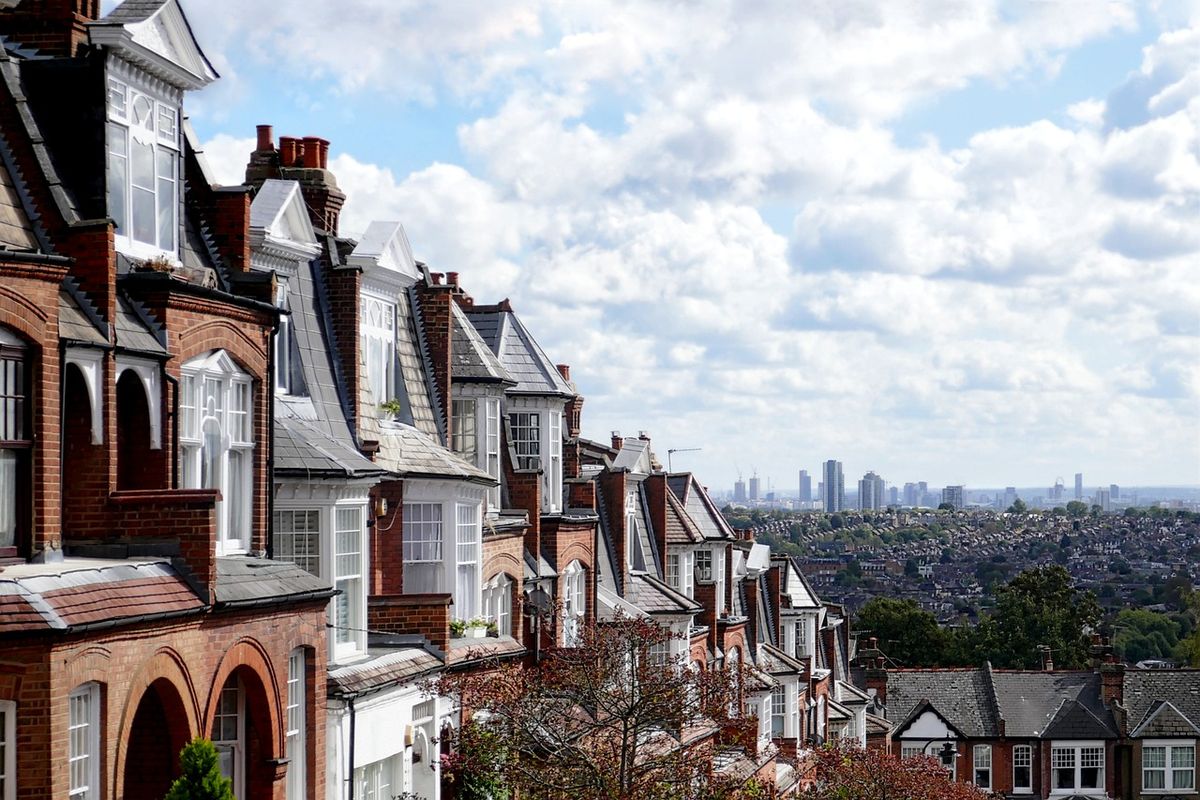 Victorian terraced street with the London skyline beyond