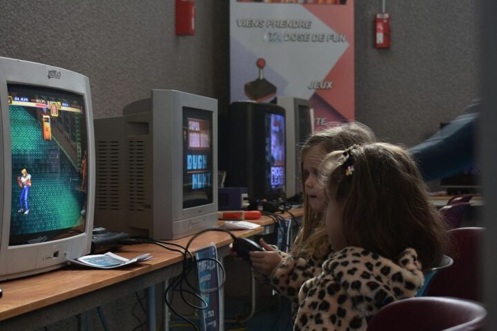 Child playing a video game on an old monitor